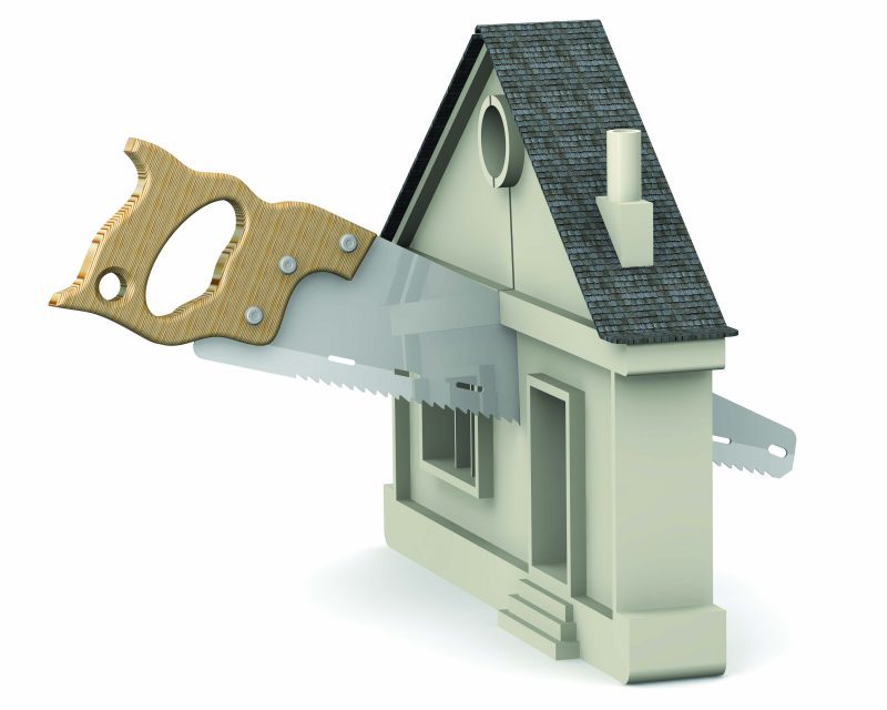 model of a house being sawn in half by a hand saw